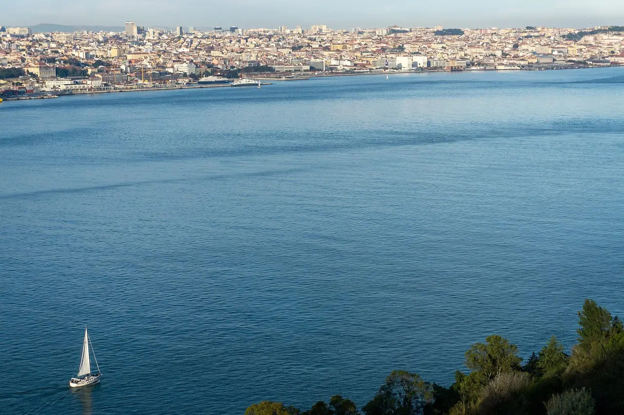 Sunset view over Lisbon's red rooftops and Tagus River from Miradouro de Santa Luzia