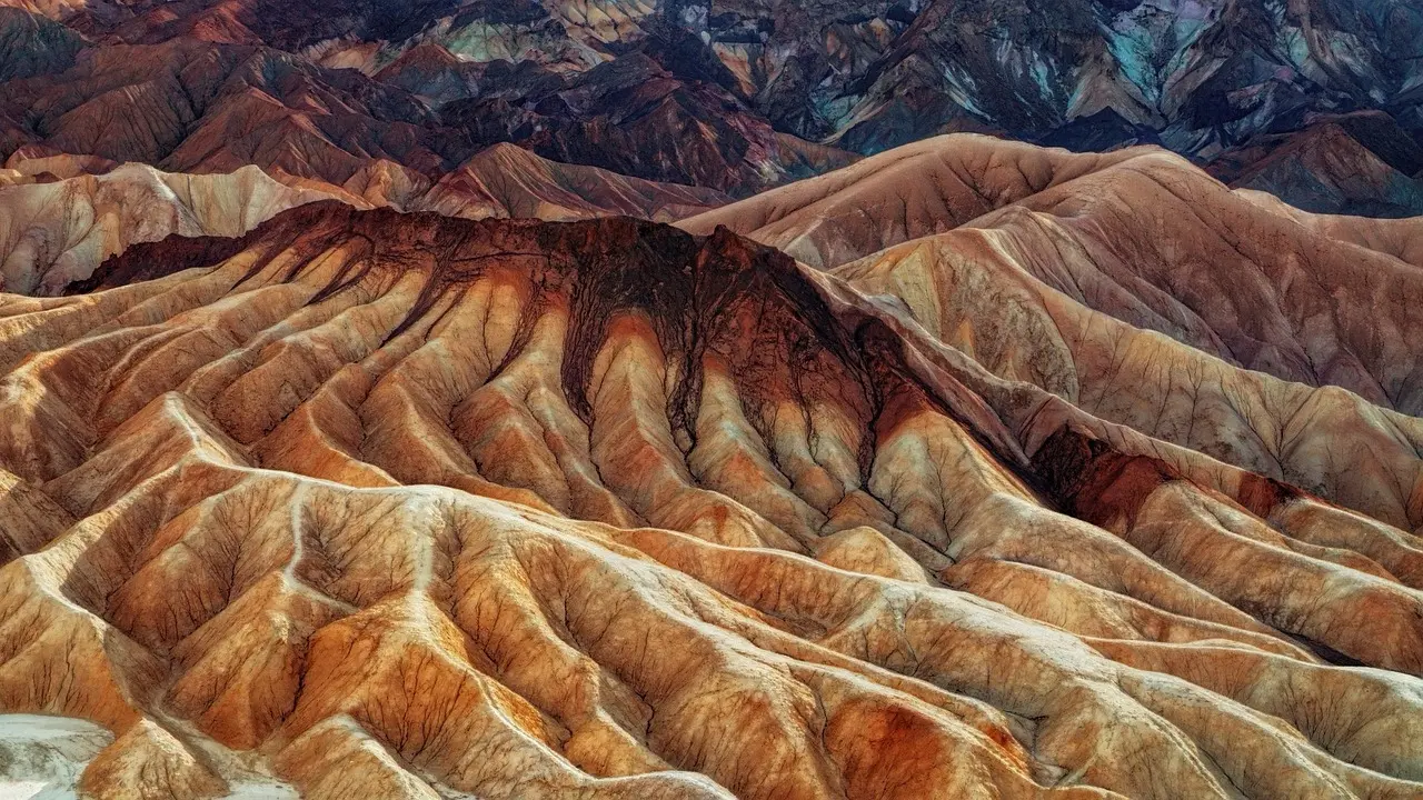 Textural beauty in motion — how wind-sculpted sandstone invites tactile and visual appreciation of natural scenery Close-up of undulating red sandstone rock formations with dramatic light and shadow at Valley of Fire State Park