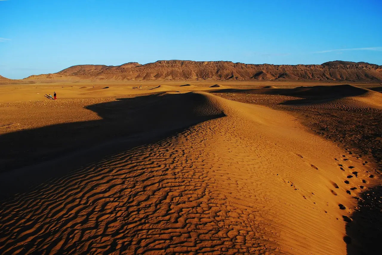 Amazigh riders executing Tbourida in the Agafay Desert — a powerful expression of cultural experience through local festivals and folk performances Group of Amazigh horsemen in traditional dress performing Fantasia in desert setting